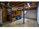 Unfinished basement with exposed ceiling pipes, utility connections, and concrete flooring at 879 Old Tucker Rd, Stone Mountain, GA 30087