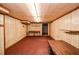 Finished basement features wood paneled walls, carpeting, and a fluorescent light fixture at 879 Old Tucker Rd, Stone Mountain, GA 30087