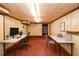 Finished basement featuring paneled walls, carpeting, and space for a home office or additional living area at 879 Old Tucker Rd, Stone Mountain, GA 30087