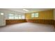 Large basement space with neutral carpet and wood paneling, ready for customization at 879 Old Tucker Rd, Stone Mountain, GA 30087