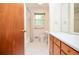 Modest bathroom featuring a tub, sink with vanity, toilet, and mirror for getting ready at 879 Old Tucker Rd, Stone Mountain, GA 30087