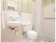 Neutral-toned bathroom featuring a sink with a mirror, toilet, and shower with retro fixtures and finishes at 879 Old Tucker Rd, Stone Mountain, GA 30087