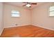 Empty bedroom featuring wood floors, neutral walls, a ceiling fan, and natural light at 879 Old Tucker Rd, Stone Mountain, GA 30087
