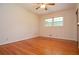 Bedroom featuring hardwood floors, neutral-toned walls, and a window that lets in natural light at 879 Old Tucker Rd, Stone Mountain, GA 30087