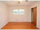 Bright bedroom featuring hardwood floors, a window with natural light, and a closet at 879 Old Tucker Rd, Stone Mountain, GA 30087