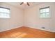 Empty bedroom with hardwood floors, neutral-toned walls, and two windows that let in natural light at 879 Old Tucker Rd, Stone Mountain, GA 30087