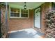 Charming front porch with brick accents and a welcoming white front door at 879 Old Tucker Rd, Stone Mountain, GA 30087
