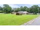 Well-maintained home featuring an expansive front lawn, mature landscaping, and a quaint garden area at 879 Old Tucker Rd, Stone Mountain, GA 30087