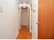 Hallway featuring hardwood floors and multiple doors, leading to various rooms in the house at 879 Old Tucker Rd, Stone Mountain, GA 30087