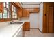 Kitchen featuring wooden cabinets, tile countertops, and bright white walls at 879 Old Tucker Rd, Stone Mountain, GA 30087
