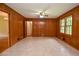 Bright living room featuring tile floors, wood paneled walls, and a ceiling fan at 879 Old Tucker Rd, Stone Mountain, GA 30087