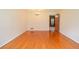 Spacious living room featuring shiny hardwood floors with a chandelier and paneled door at 879 Old Tucker Rd, Stone Mountain, GA 30087
