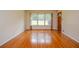Spacious living room featuring lustrous hardwood floors and a large window for natural light at 879 Old Tucker Rd, Stone Mountain, GA 30087