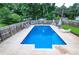 Full, wide view of a large, rectangular swimming pool surrounded by a wooden fence at 879 Old Tucker Rd, Stone Mountain, GA 30087