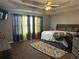 A neutral bedroom has a king size bed with an upholstered headboard and a carpeted floor at 989 Park Knoll Ct, Lawrenceville, GA 30043