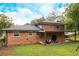 Brick home with a spacious backyard and covered patio, perfect for outdoor entertaining at 1392 Cornwall Rd, Decatur, GA 30032