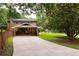 Brick home with a long driveway and carport showcasing classic suburban architecture at 1392 Cornwall Rd, Decatur, GA 30032