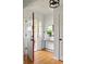 Bright foyer with hardwood floors, modern lighting, and a round mirror accenting the entryway at 1392 Cornwall Rd, Decatur, GA 30032