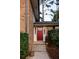 Charming red front door with sidelights and concrete steps leading to a well-maintained brick facade at 1392 Cornwall Rd, Decatur, GA 30032