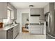 Bright kitchen features gray cabinets, granite countertops, subway tile backsplash, and stainless steel appliances at 1392 Cornwall Rd, Decatur, GA 30032