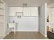 Tiled laundry room with utility sink and plenty of cabinets at 1392 Cornwall Rd, Decatur, GA 30032
