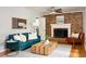 Bright living room with brick fireplace, wooden coffee table, hardwood floors, and ample natural light at 1392 Cornwall Rd, Decatur, GA 30032