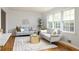Inviting living room with hardwood floors, stylish decor, and plenty of natural light from the windows at 1392 Cornwall Rd, Decatur, GA 30032