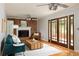 Cozy living room with brick fireplace, wooden coffee table, hardwood floors, and ample natural light at 1392 Cornwall Rd, Decatur, GA 30032