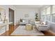 Cozy living room features neutral sofas, a decorative rug, and large windows providing natural light at 1392 Cornwall Rd, Decatur, GA 30032