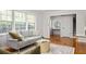 Comfortable living room with hardwood floors, a neutral sofa, and easy access to the foyer and stairs at 1392 Cornwall Rd, Decatur, GA 30032