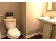 Cozy half-bathroom featuring a toilet and pedestal sink at 1783 Shetley Creek Drive, Norcross, GA 30071
