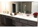 Bathroom vanity with double sinks, a light countertop, and a large mirror at 1783 Shetley Creek Drive, Norcross, GA 30071