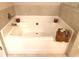 This bathtub has decorative tiling and a bundle of towels for styling at 1783 Shetley Creek Drive, Norcross, GA 30071