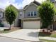 Attractive townhome with a spacious driveway and a well-kept lawn, and stone facade on the garage at 1783 Shetley Creek Drive, Norcross, GA 30071