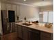 This kitchen features a stainless steel refrigerator and a center island with a sink and a light countertop at 1783 Shetley Creek Drive, Norcross, GA 30071