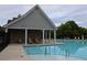 Community pool area with a covered pavilion and ample seating, surrounded by lush landscaping at 1783 Shetley Creek Drive, Norcross, GA 30071