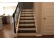 View of the home's staircase with dark wood treads and black iron railings at 1783 Shetley Creek Drive, Norcross, GA 30071