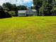 Expansive backyard featuring a deck, sunroom, and a large green lawn at 208 Arbour Way, Suwanee, GA 30024