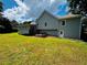 Beautiful backyard showcasing a deck, sunroom, and lush green lawn at 208 Arbour Way, Suwanee, GA 30024