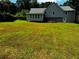 Large backyard showing the home's exterior, deck, and sunroom at 208 Arbour Way, Suwanee, GA 30024