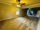Large bedroom with plush carpet, ceiling fan, neutral paint, and a glimpse into an attached bathroom at 208 Arbour Way, Suwanee, GA 30024