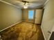 Neutral bedroom featuring a ceiling fan, large window, neutral carpeting and a closet at 208 Arbour Way, Suwanee, GA 30024