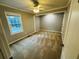 Comfortable bedroom with carpet flooring, ceiling fan, and a window providing natural light at 208 Arbour Way, Suwanee, GA 30024