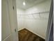 Walk-in closet featuring wire shelving, neutral carpeting, and plenty of storage space at 208 Arbour Way, Suwanee, GA 30024