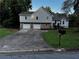 Charming two-story home featuring a light blue exterior, stone accents, a two-car garage, and a well-manicured lawn at 208 Arbour Way, Suwanee, GA 30024