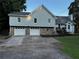 Charming two-story home featuring a light blue exterior, stone accents, a two-car garage, and a well-manicured lawn at 208 Arbour Way, Suwanee, GA 30024
