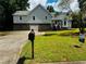 Charming home featuring a manicured lawn, stone accents, and a two-car garage at 208 Arbour Way, Suwanee, GA 30024