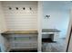 Hallway with built-in shelving, hooks, and a desk area at 208 Arbour Way, Suwanee, GA 30024