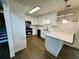Stylish kitchen featuring white cabinets, stainless steel appliances, and an inviting breakfast bar at 208 Arbour Way, Suwanee, GA 30024