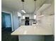 Modern kitchen with white cabinetry, stainless steel appliances, and countertop with bar seating at 208 Arbour Way, Suwanee, GA 30024